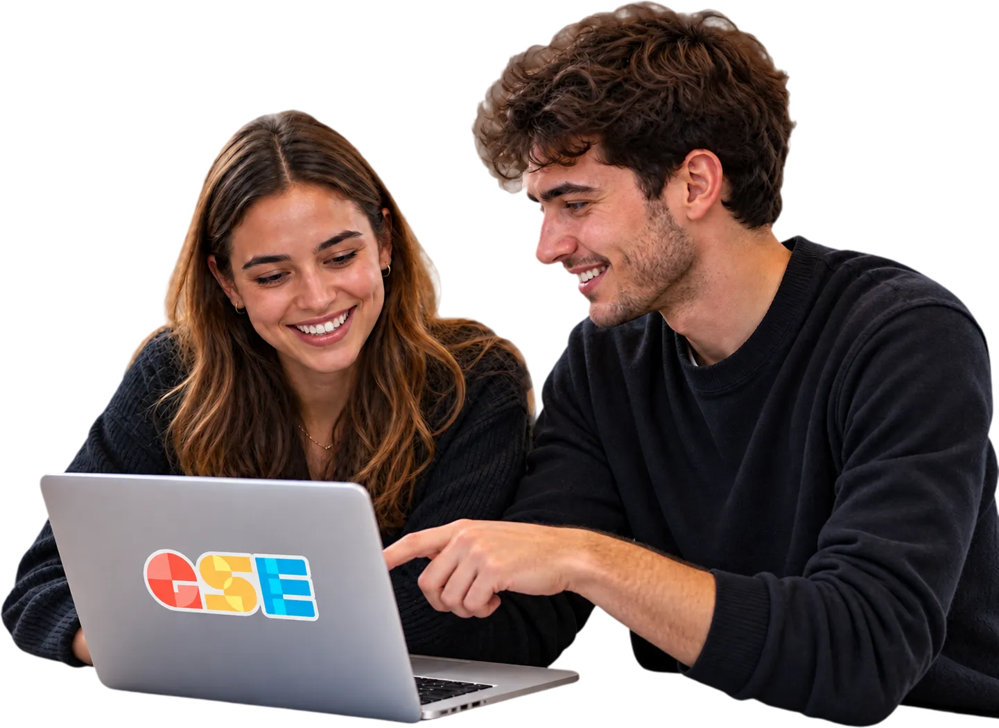 Two students sharing ideas around a laptop.