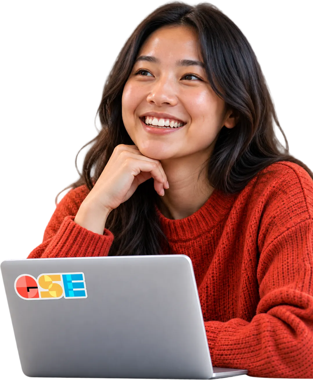 A student smiling next to a laptop.