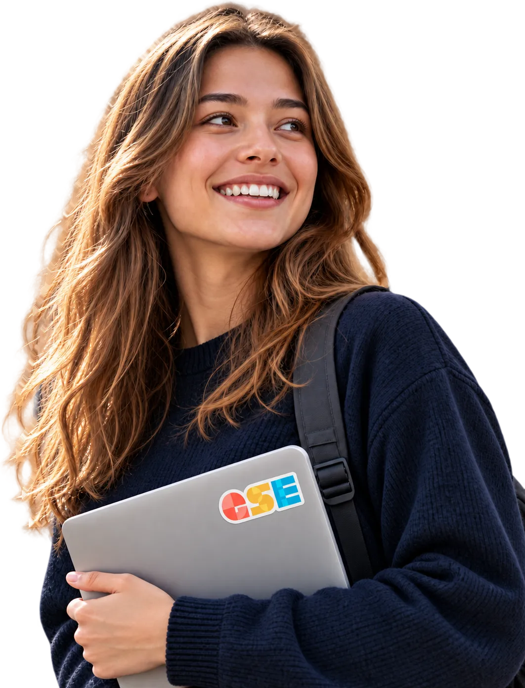 A smiling student holding a laptop.